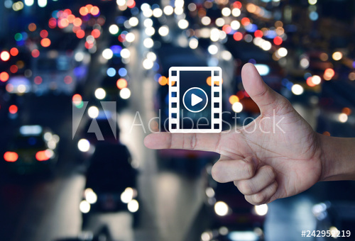 500x340 Play Button With Movie Icon On Finger Over Blur Colorful Night