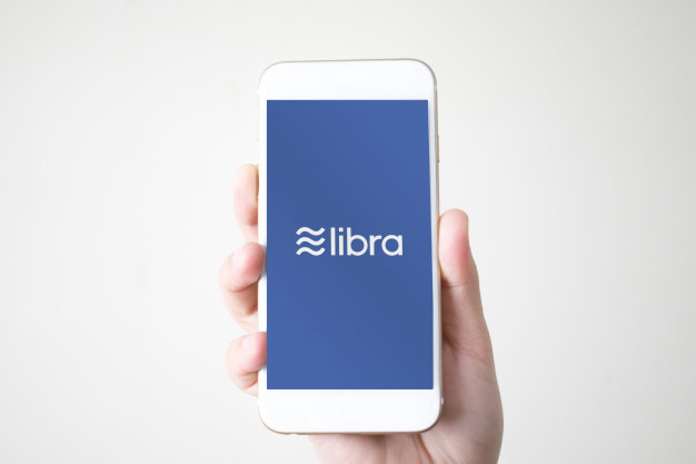 626x417 Hands Holding A Smart Phone With Icon Libra Facebook