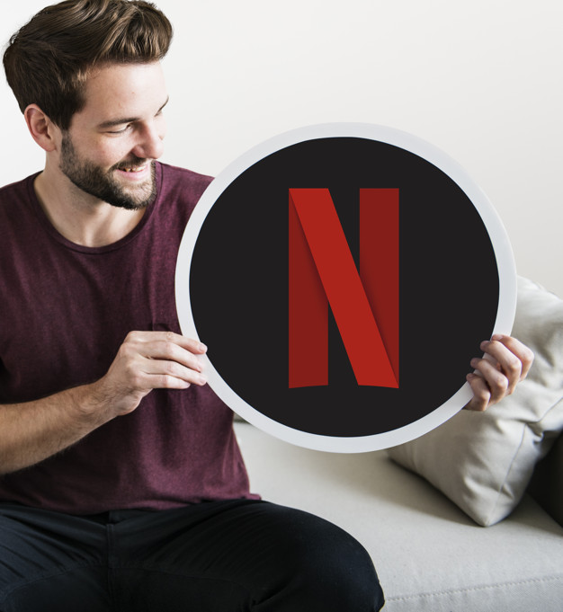 626x681 Cheerful Man Holding A Netflix Icon Photo Free Download