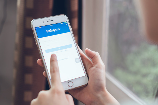 626x417 Hand Is Pressing The Login Screen Instagram Icons On Apple Iphone